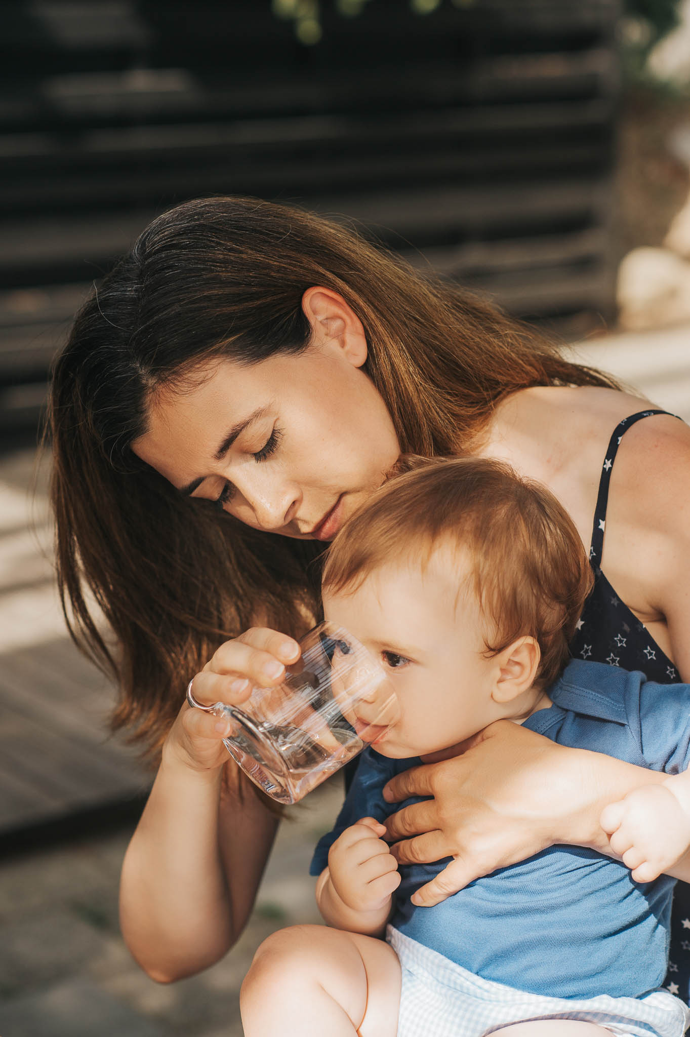 mother giving toddler water