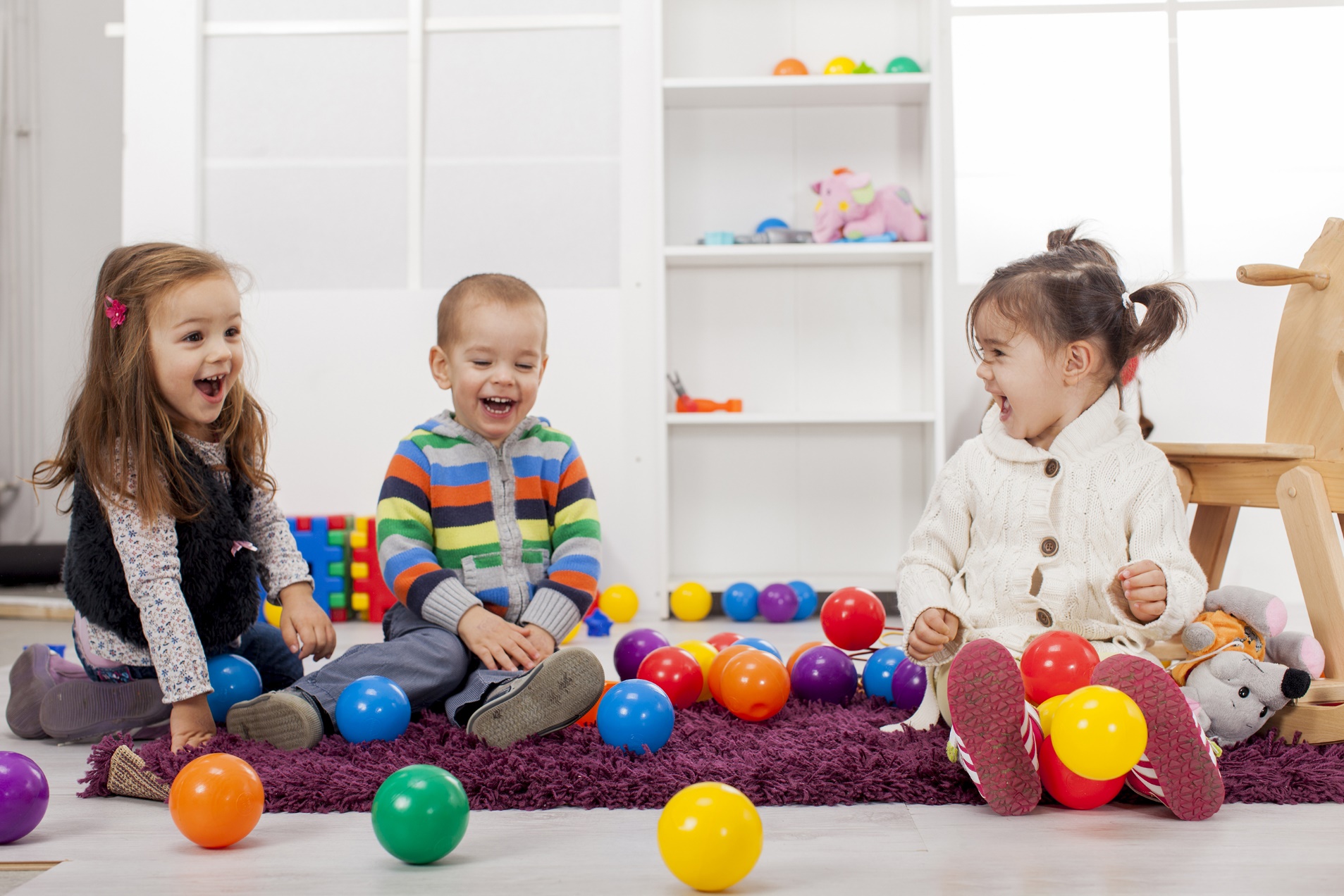 Young children playing with balls in a nursery